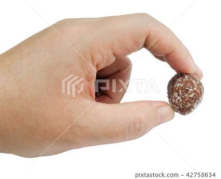Hand Holding Chocolate Candy Balls with Grate Coco Hand Holding Chocolate Candy Balls with Grate Coco 42758634