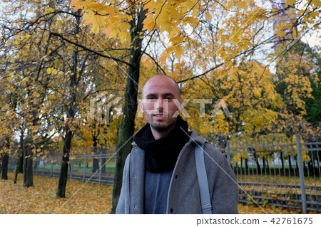 Young man stands against the fall background Young man stands against the fall background 42761675