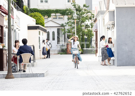 A young woman riding a bicycle 42762652