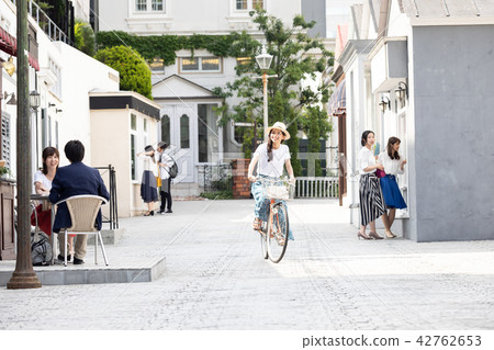 A young woman riding a bicycle 42762653