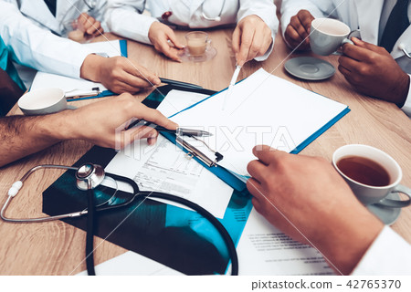 Multinational Doctor's Hands On Paper Desk Blank. 42765370