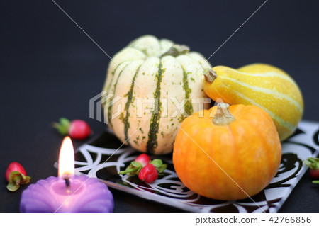 Toy pumpkin and candle 42766856