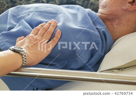 Woman Touched and Praying For Sick Old Man. 42769734
