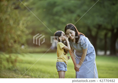 Mother and child talking together on the lawn Mother and child talking together on the lawn 42770482