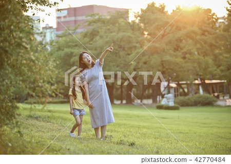 Mother and child talking together on the lawn Mother and child talking together on the lawn 42770484
