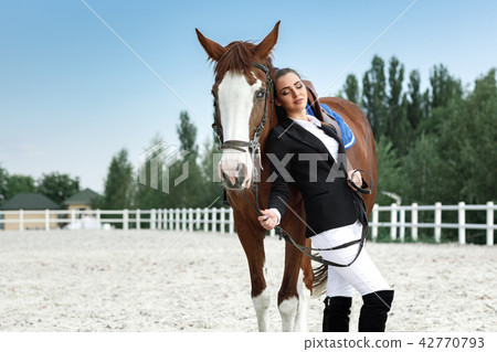 Rider elegant woman riding her horse outside Rider elegant woman riding her horse outside 42770793