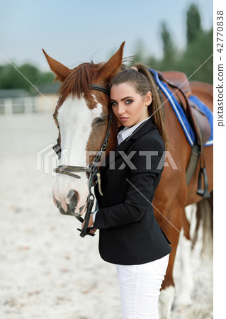 Rider elegant woman riding her horse outside 42770838