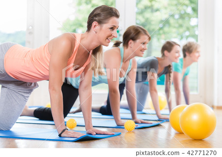 Moms in postnatal regression course doing yoga asana Moms in postnatal regression course doing yoga asana 42771270