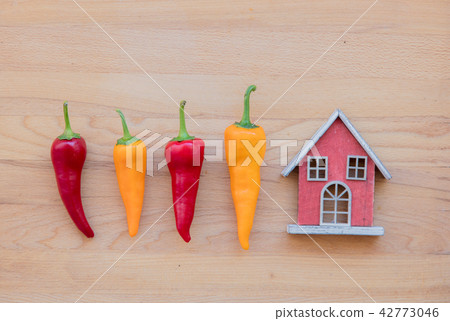 yellow and red peppers with toy house yellow and red peppers with toy house 42773046