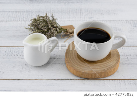 A cup of coffee and milk with caspia bouquet A cup of coffee and milk with caspia bouquet 42773052