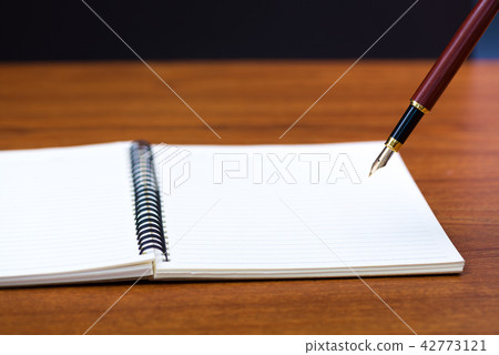 Close up of fountain pen with notebook paper Close up of fountain pen with notebook paper 42773121
