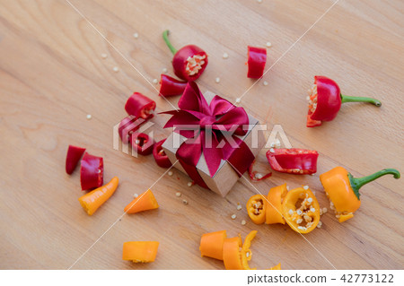 cut yellow and red peppers with gift box 42773122