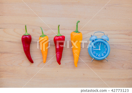 chilli peppers and alarm clock chilli peppers and alarm clock 42773123