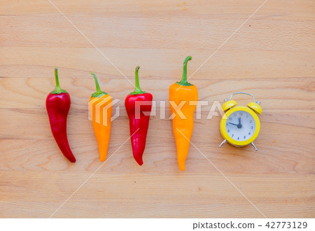 chilli peppers and alarm clock chilli peppers and alarm clock 42773129
