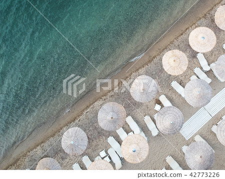Beach with umbrellas and a bright water Beach with umbrellas and a bright water 42773226