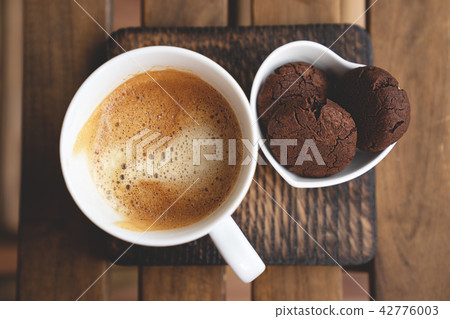 Chocolate cookies with dark chocolate and cup of coffee on a wooden background. Chocolate cookies with dark chocolate and cup of coffee on a wooden background. 42776003