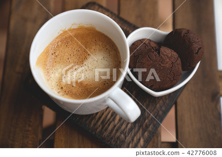 Chocolate cookies with dark chocolate and cup of coffee on a wooden background. Chocolate cookies with dark chocolate and cup of coffee on a wooden background. 42776008