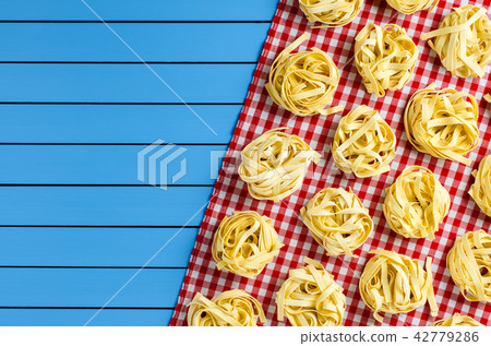 Pasta on blue wooden table Pasta on blue wooden table 42779286