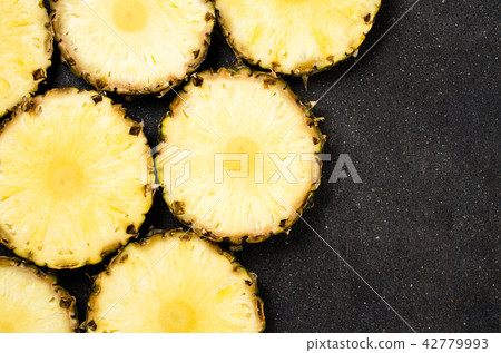 Pineapple slices on dark background Pineapple slices on dark background 42779993