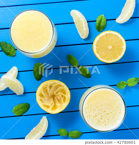 Lemon juice on blue wooden table 42780001