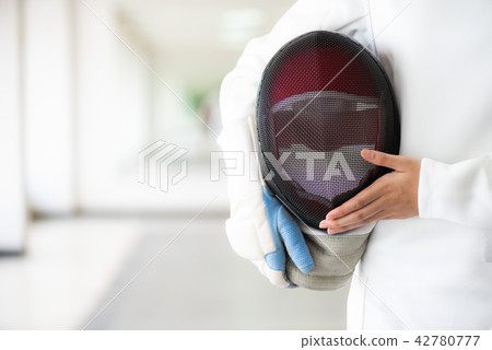 A fencer in white fencing suit A fencer in white fencing suit 42780777