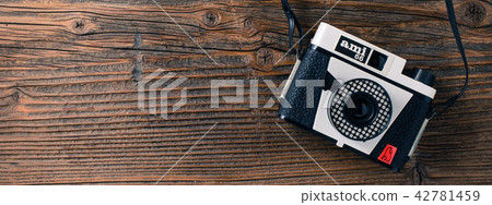 Old camera over wooden table Old camera over wooden table 42781459