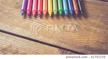 Colorful markers on yellow wooden table. Close up 42781539