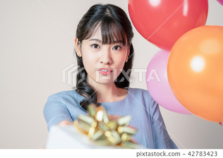 Woman with balloons and presents Woman with balloons and presents 42783423