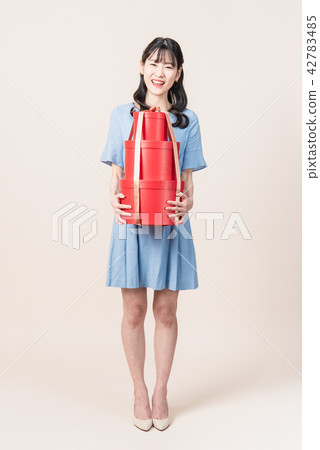 Woman with a gift box Woman with a gift box 42783485