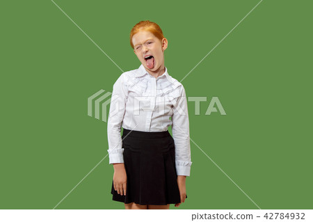The squint eyed woman with weird expression isolated on green The squint eyed woman with weird expression isolated on green 42784932