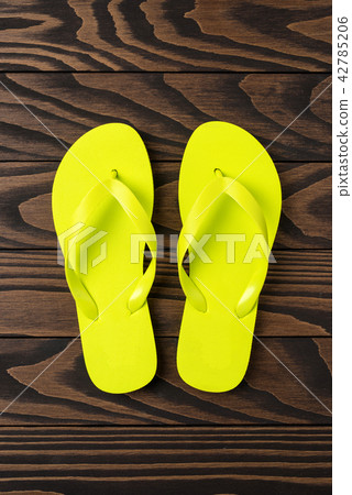 Flip flops on wooden background. Close up 42785206