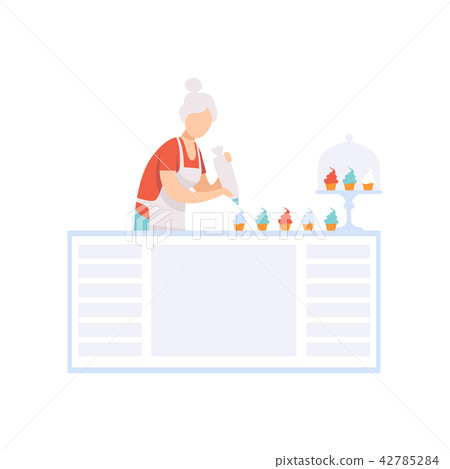 Senior woman character baking cupcakes in the kitchen, elderly people leading an active lifestyle Senior woman character baking cupcakes in the kitchen, elderly people leading an active lifestyle 42785284