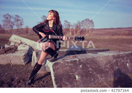 girl with guitar in leather jacket girl with guitar in leather jacket 42787164