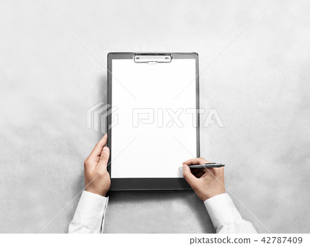 Hand signing blank black clipboard with white a4 paper design mockup Hand signing blank black clipboard with white a4 paper design mockup 42787409