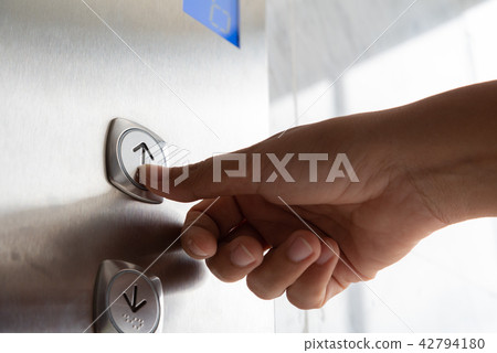 "นman hand press a up button of elevator "นman hand press a up button of elevator 42794180