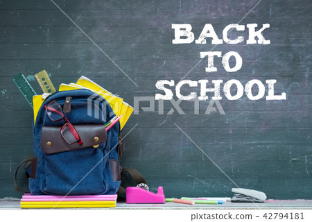 School supplies with chalkboard background. School supplies with chalkboard background. 42794181
