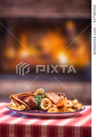 Festive garnished roast duck with apple. Festive garnished roast duck with apple. 42796402