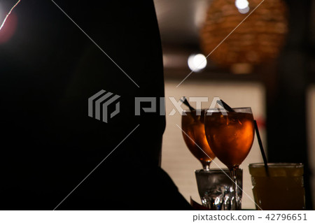 Silhouette of woman drinking alcoholic beverage Silhouette of woman drinking alcoholic beverage 42796651