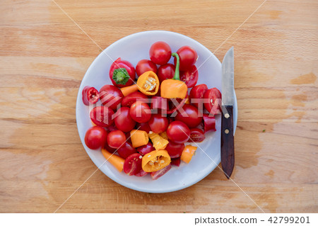 Knife and tomatoes in plate Knife and tomatoes in plate 42799201