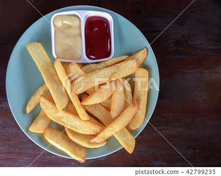 French fries in plate mayonnaise tomato sauce 42799235