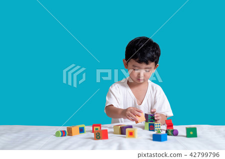 3 years old Asian boy play square block puzzle 3 years old Asian boy play square block puzzle 42799796