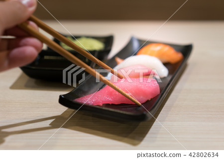 Chopsticks with Japan raw tuna sushi Chopsticks with Japan raw tuna sushi 42802634