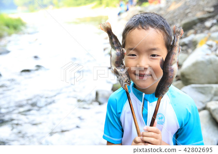 Children enjoying fishing Children enjoying fishing 42802695