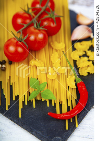 Raw pasta, chili, tomatoes and basil 42804226