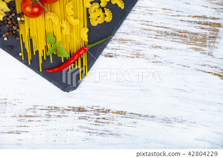 Raw pasta, chili, tomatoes and basil Raw pasta, chili, tomatoes and basil 42804229