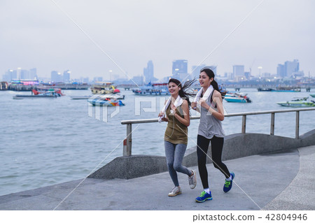 Sports concept. Beautiful girl is exercising on the beach with r 42804946