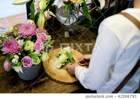 Cheerful charming young business flower shop  42806795