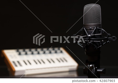 microphone on music keyboard background microphone on music keyboard background 42807903