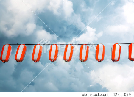 Paper red-white japanese lanterns Chochin hanging on blue sky background 42811059