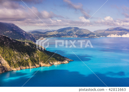 Picturesque rocky coastline on Kefalonia island. Amazing watercolor landscape in sunset light with Picturesque rocky coastline on Kefalonia island. Amazing watercolor landscape in sunset light with 42811663